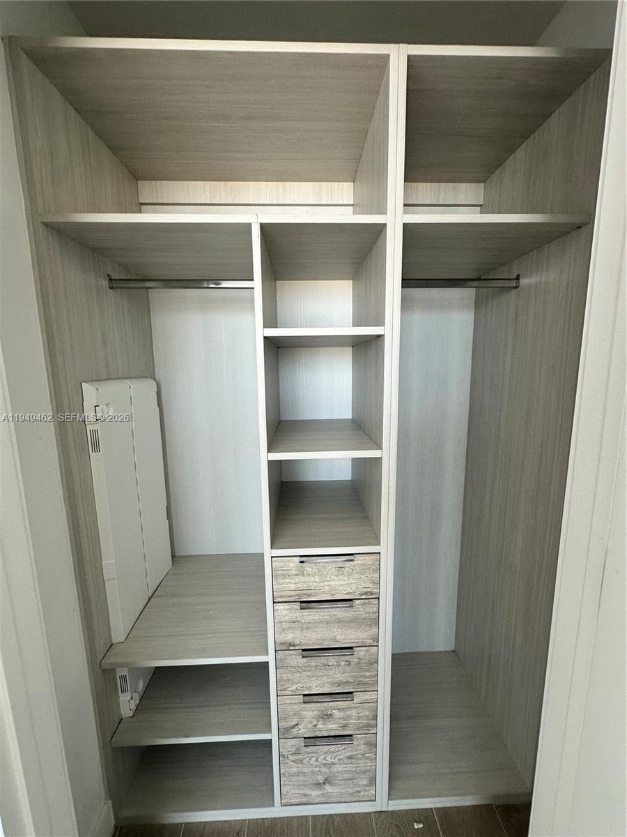 500 Alton Road, Unit 1408 Miami Beach, FL 33139 - Photo 4 of 21 a view of walk in closet with empty racks
