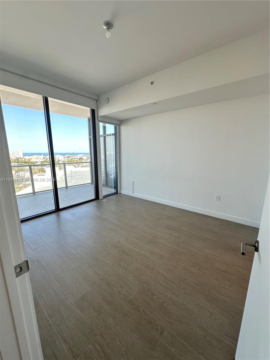 500 Alton Road, Unit 1408 Miami Beach, FL 33139 - Photo 7 of 21 an empty room with windows