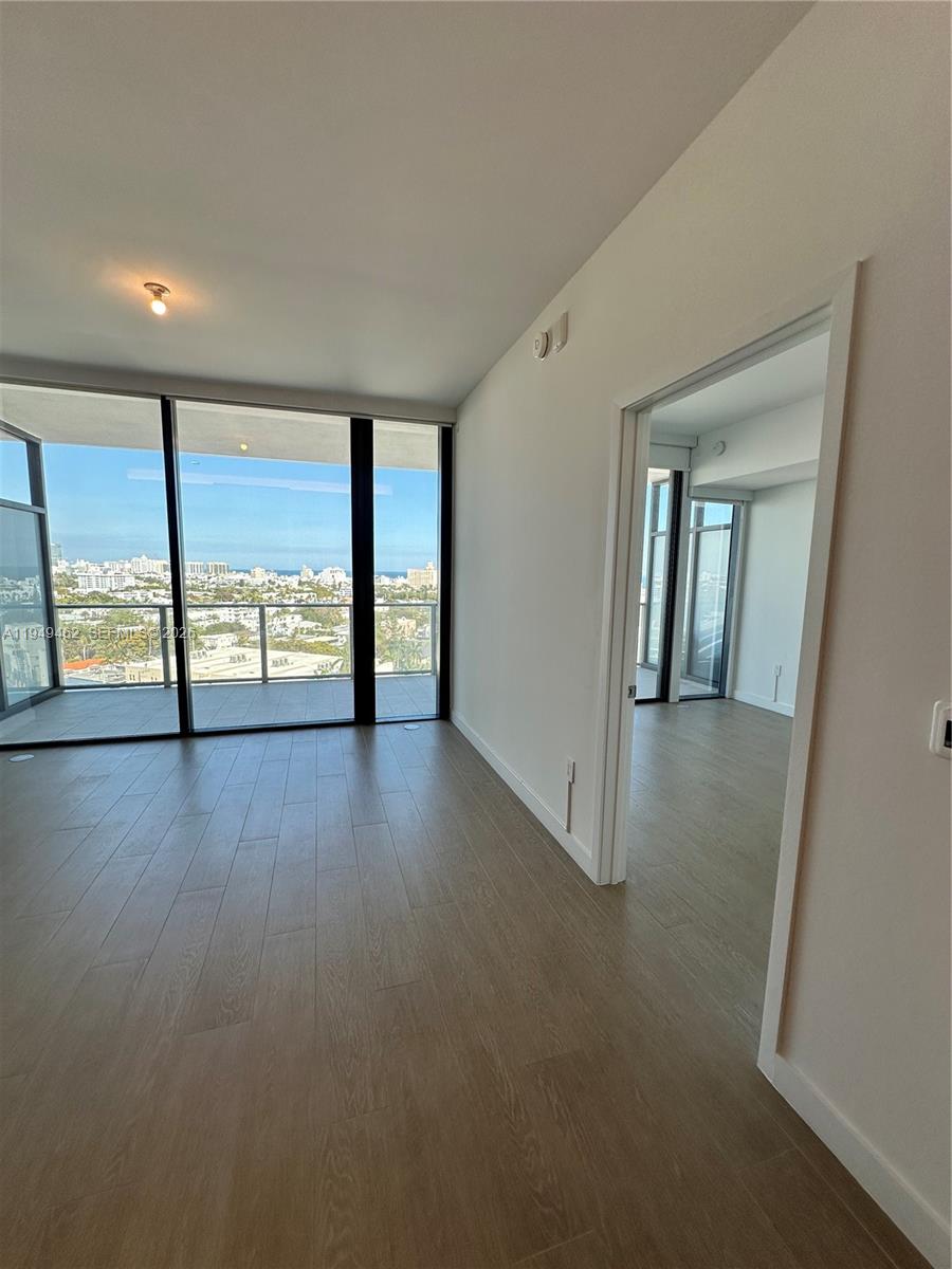 500 Alton Road, Unit 1408 Miami Beach, FL 33139 - Photo 8 of 21 wooden floor in an empty room with a window
