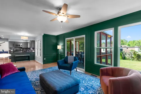 a living room with furniture fireplace and a large window
