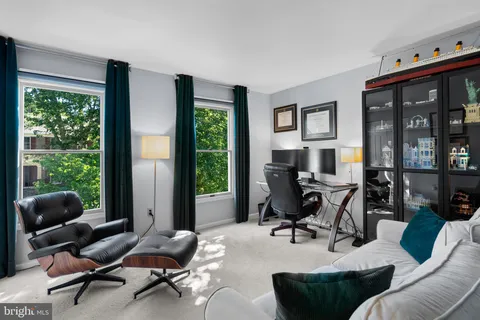 a work room with furniture and a large window