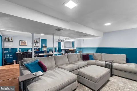 a living room with furniture and wooden floor