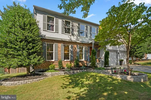 a front view of a house with a yard table and chairs