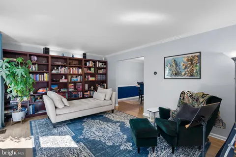 a living room with furniture and book shelf