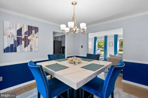 a view of a dining room with a table and chairs