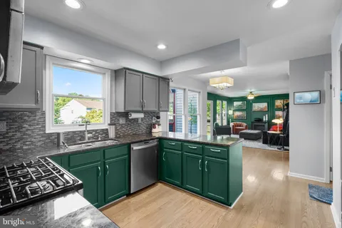 a kitchen with lots of counter top space sink and stainless steel appliances