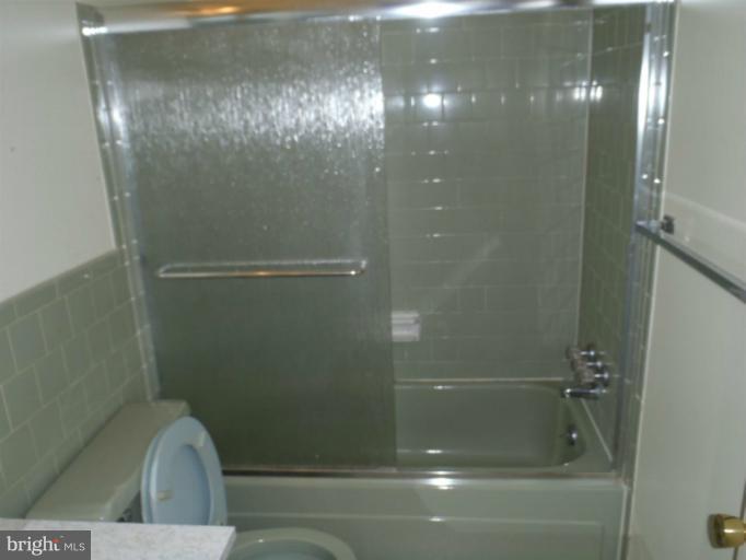 1318 Gatefield Road Catonsville, MD 21228 - Photo 2 of 14 a bathroom with a glass shower door