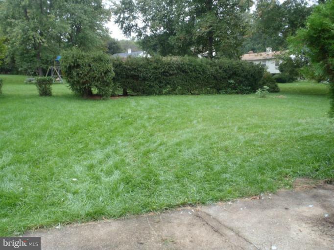 1318 Gatefield Road Catonsville, MD 21228 - Photo 11 of 14 a view of a grassy field with trees in the background