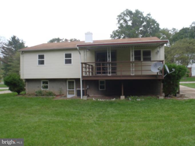 1318 Gatefield Road Catonsville, MD 21228 - Photo 6 of 14 a front view of a house with a garden and plants
