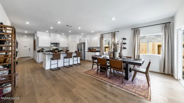 a view of a dining room with furniture window and wooden floor