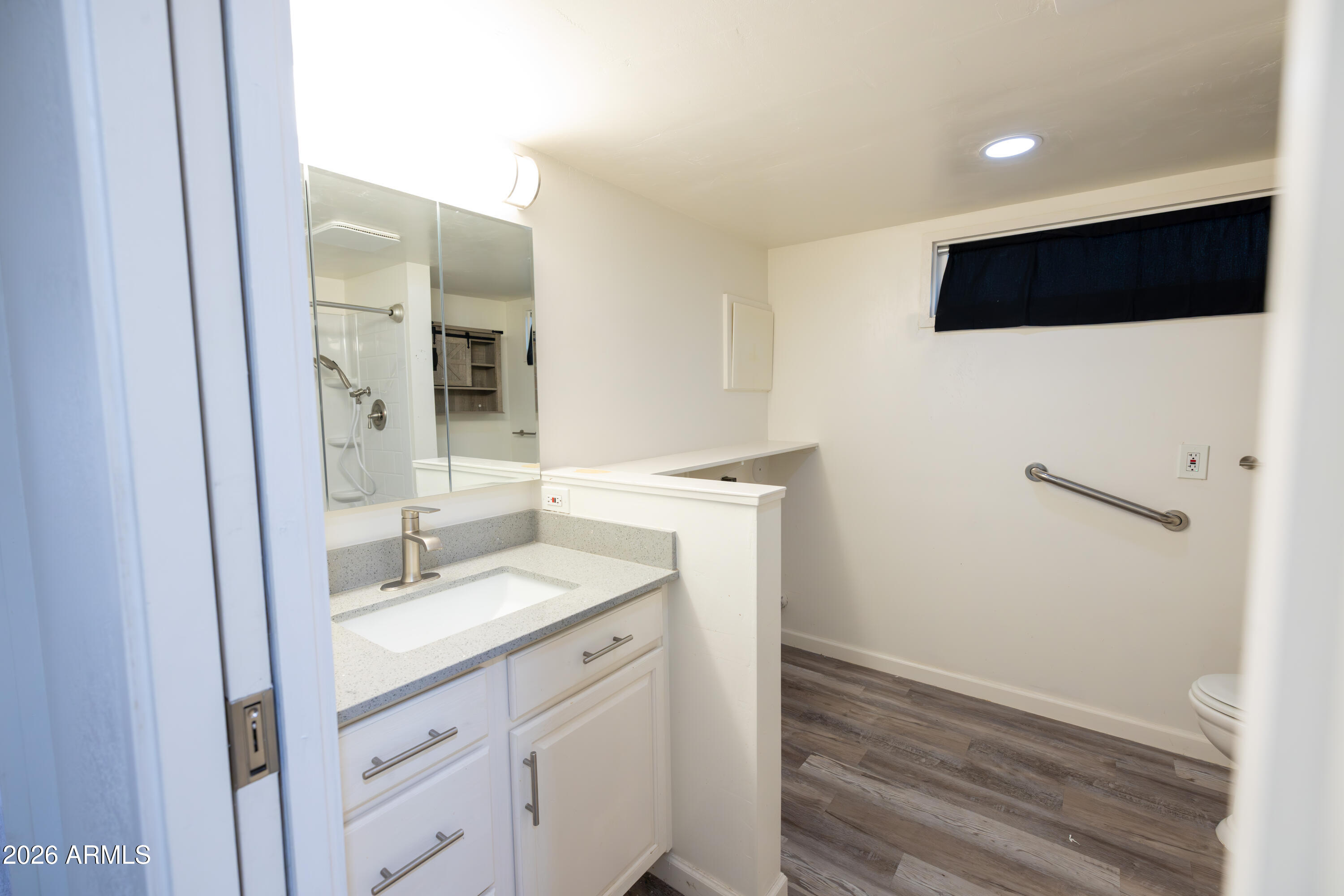 535 South Alma School Road, Unit 17 Mesa, AZ 85210 - Photo 16 of 17 a bathroom with a sink a toilet and mirror