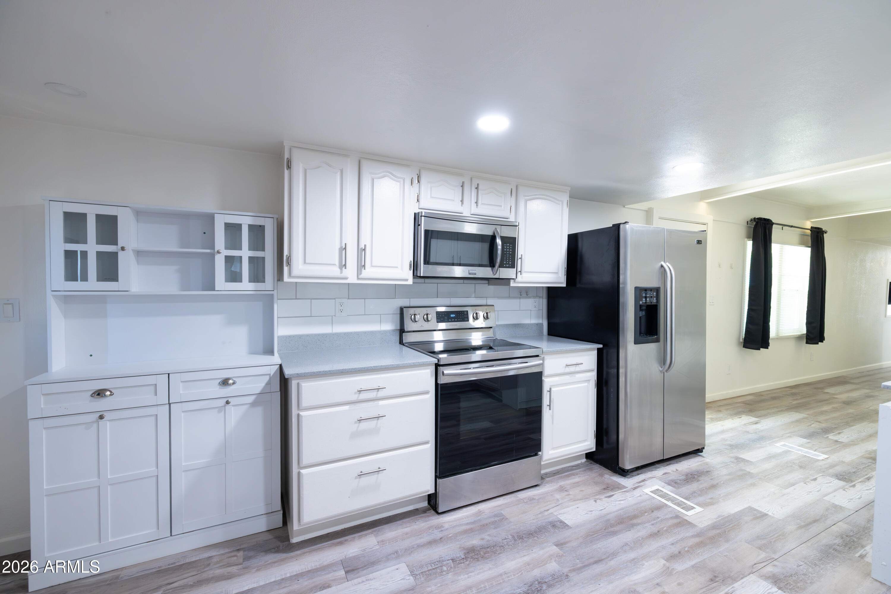 535 South Alma School Road, Unit 17 Mesa, AZ 85210 - Photo 4 of 17 a kitchen with stainless steel appliances granite countertop a refrigerator stove and sink