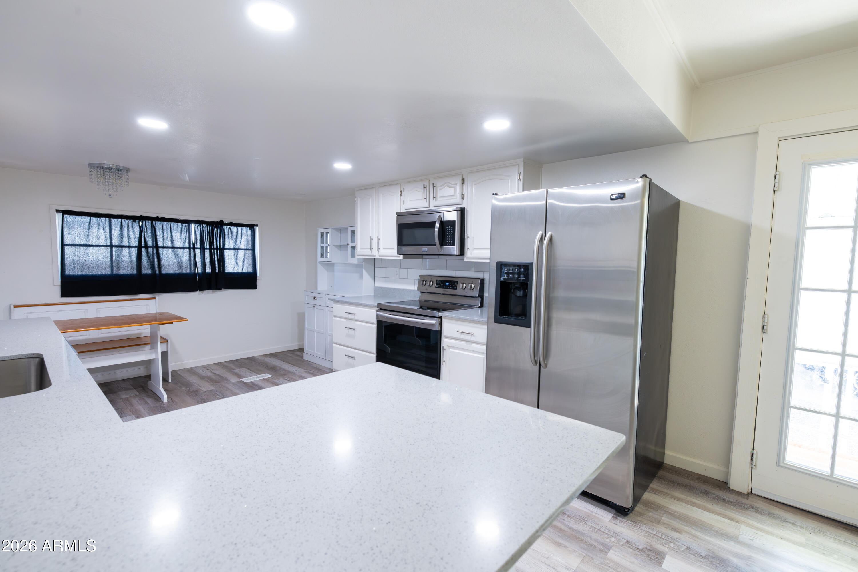 535 South Alma School Road, Unit 17 Mesa, AZ 85210 - Photo 5 of 17 a kitchen with granite countertop a refrigerator and a stove top oven