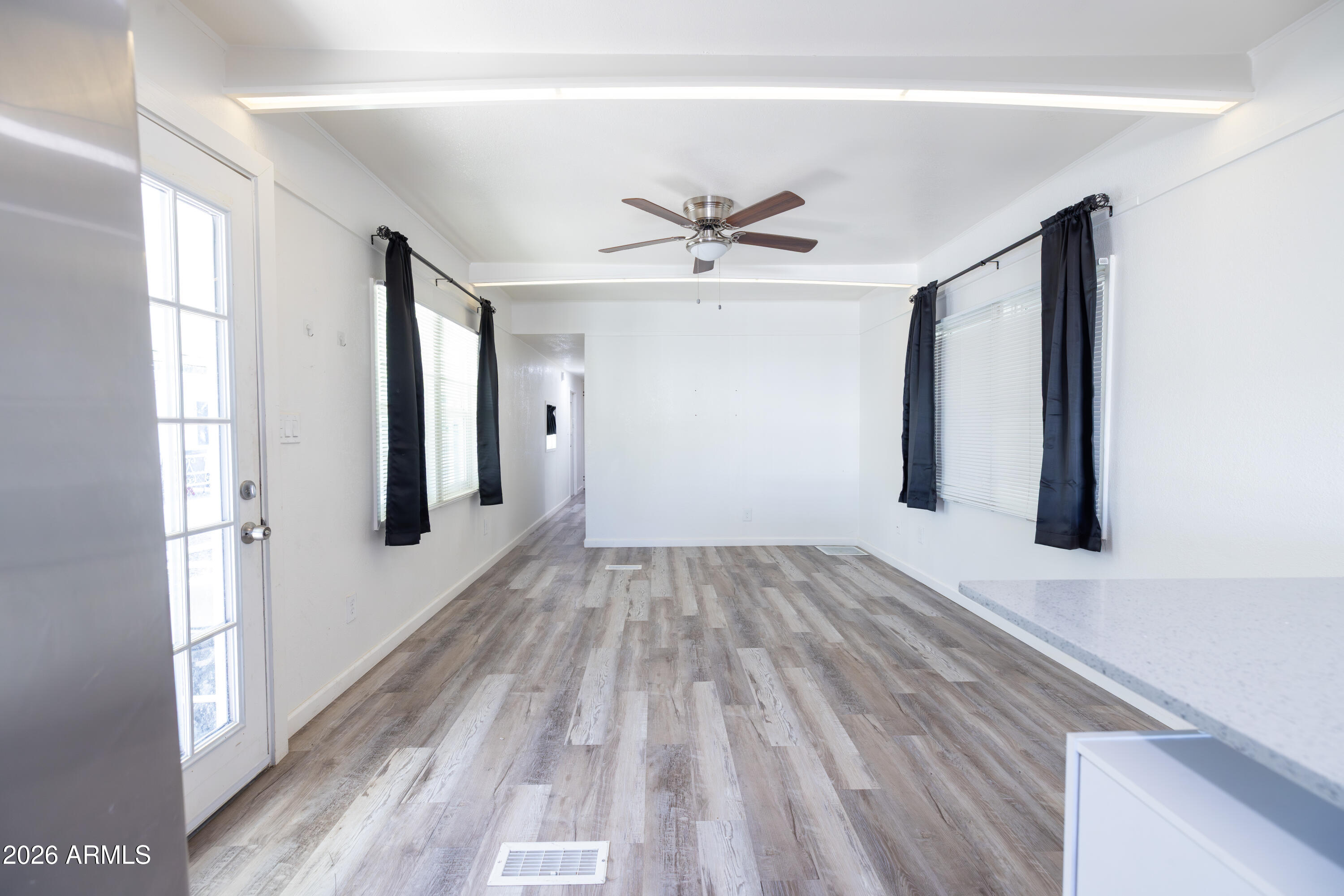 535 South Alma School Road, Unit 17 Mesa, AZ 85210 - Photo 7 of 17 a view of empty room with wooden floor and fan