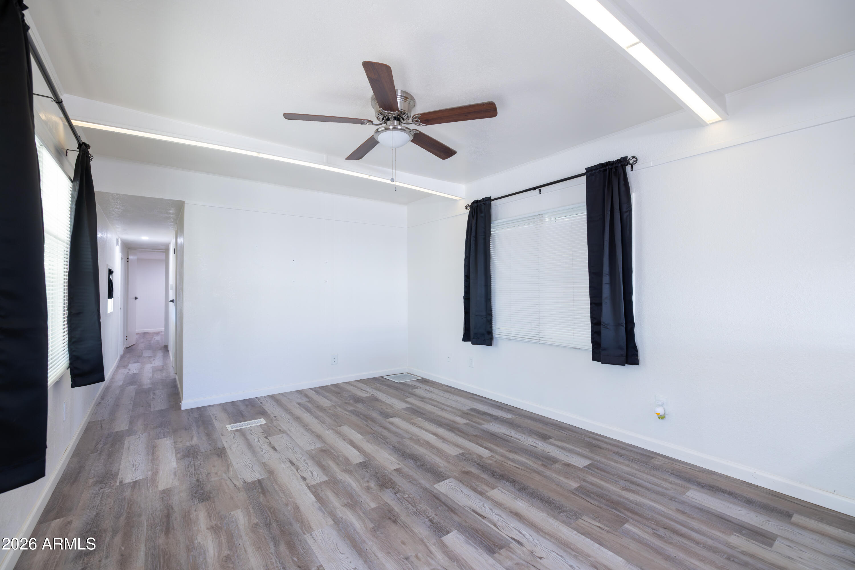 535 South Alma School Road, Unit 17 Mesa, AZ 85210 - Photo 8 of 17 a view of a big room with wooden floor and windows