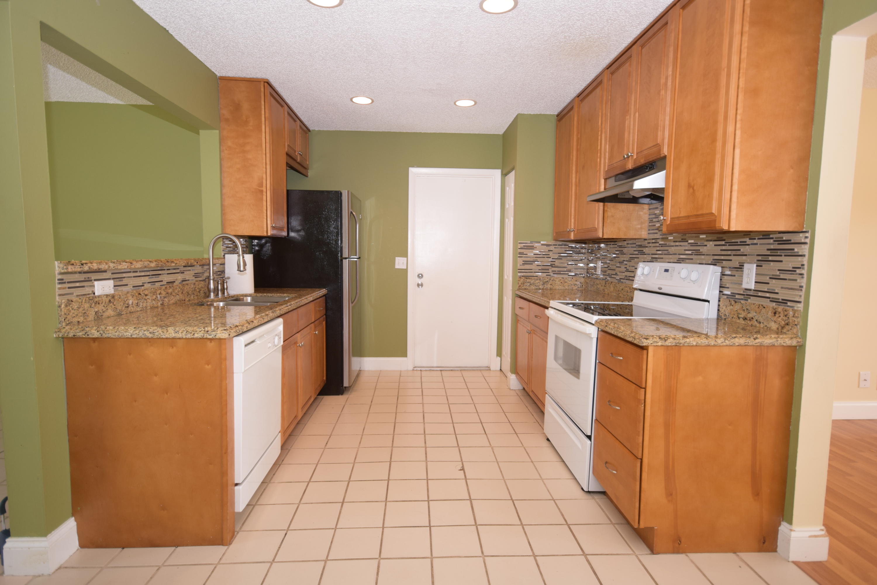 9129 Affirmed Lane Boca Raton, FL 33496 - Photo 4 of 12 a kitchen with stainless steel appliances granite countertop a refrigerator a stove and a sink