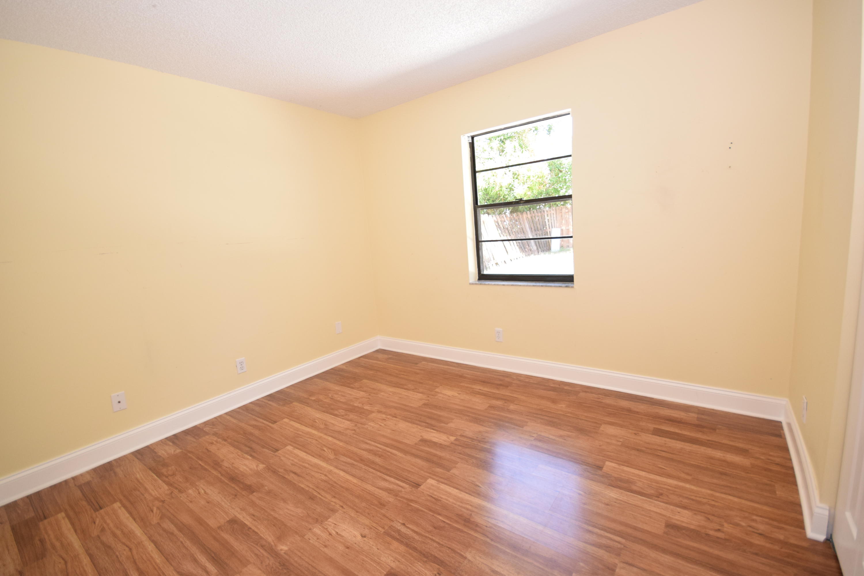 9129 Affirmed Lane Boca Raton, FL 33496 - Photo 9 of 12 an empty room with wooden floor and windows