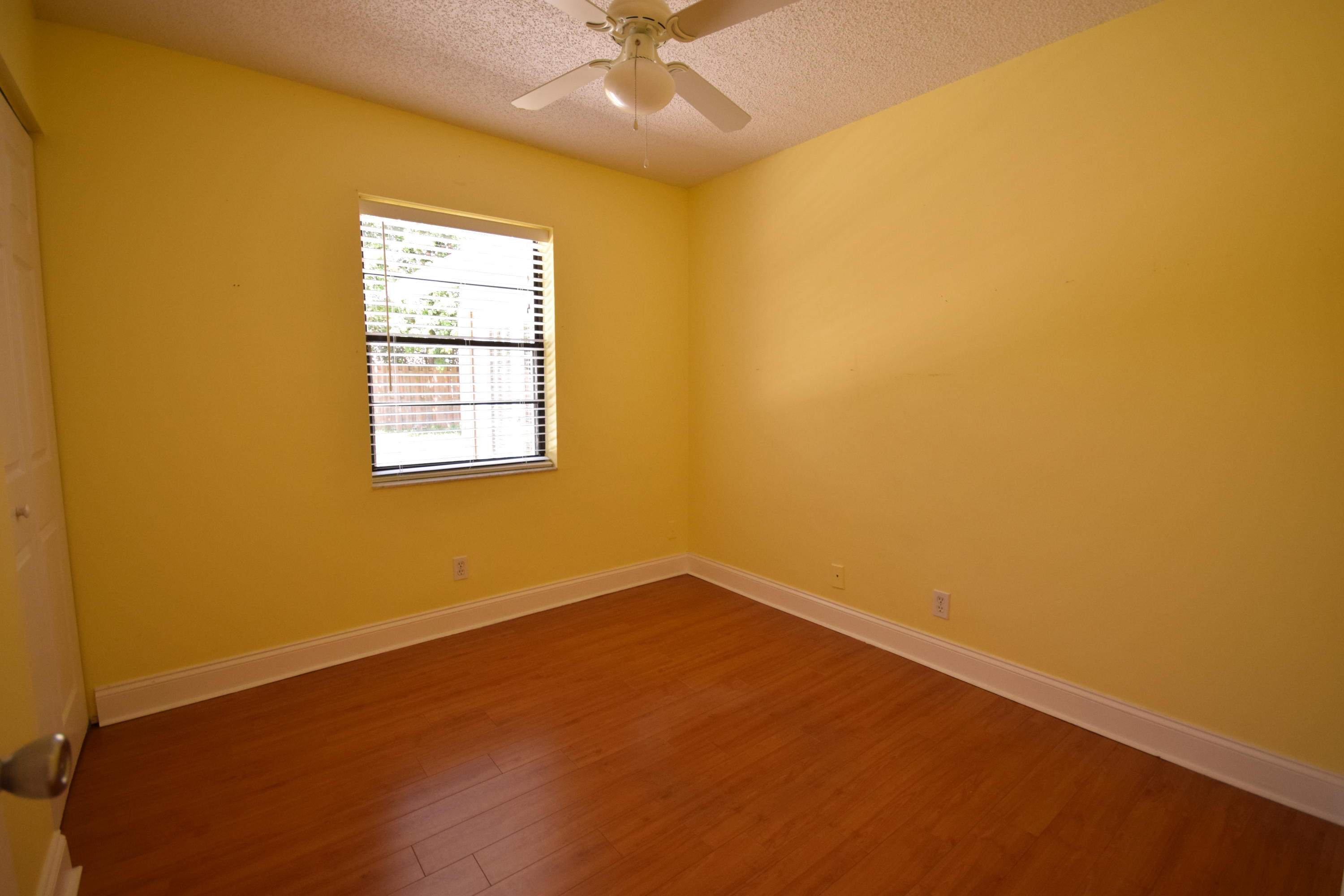 9129 Affirmed Lane Boca Raton, FL 33496 - Photo 10 of 12 an empty room with a window and a ceiling fan