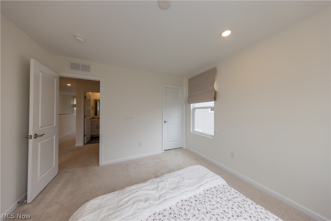 766 River Run Road Aurora, OH 44202 - Photo 30 of 49 Bedroom with light colored carpet and recessed lighting