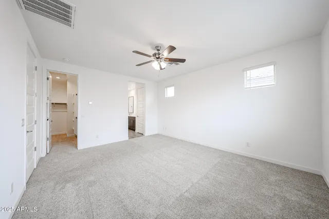 an empty room with fan and a ceiling fan