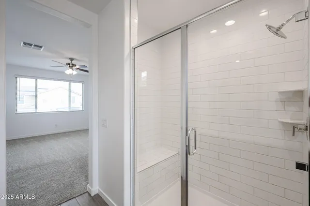 a bathroom with a shower and a glass door