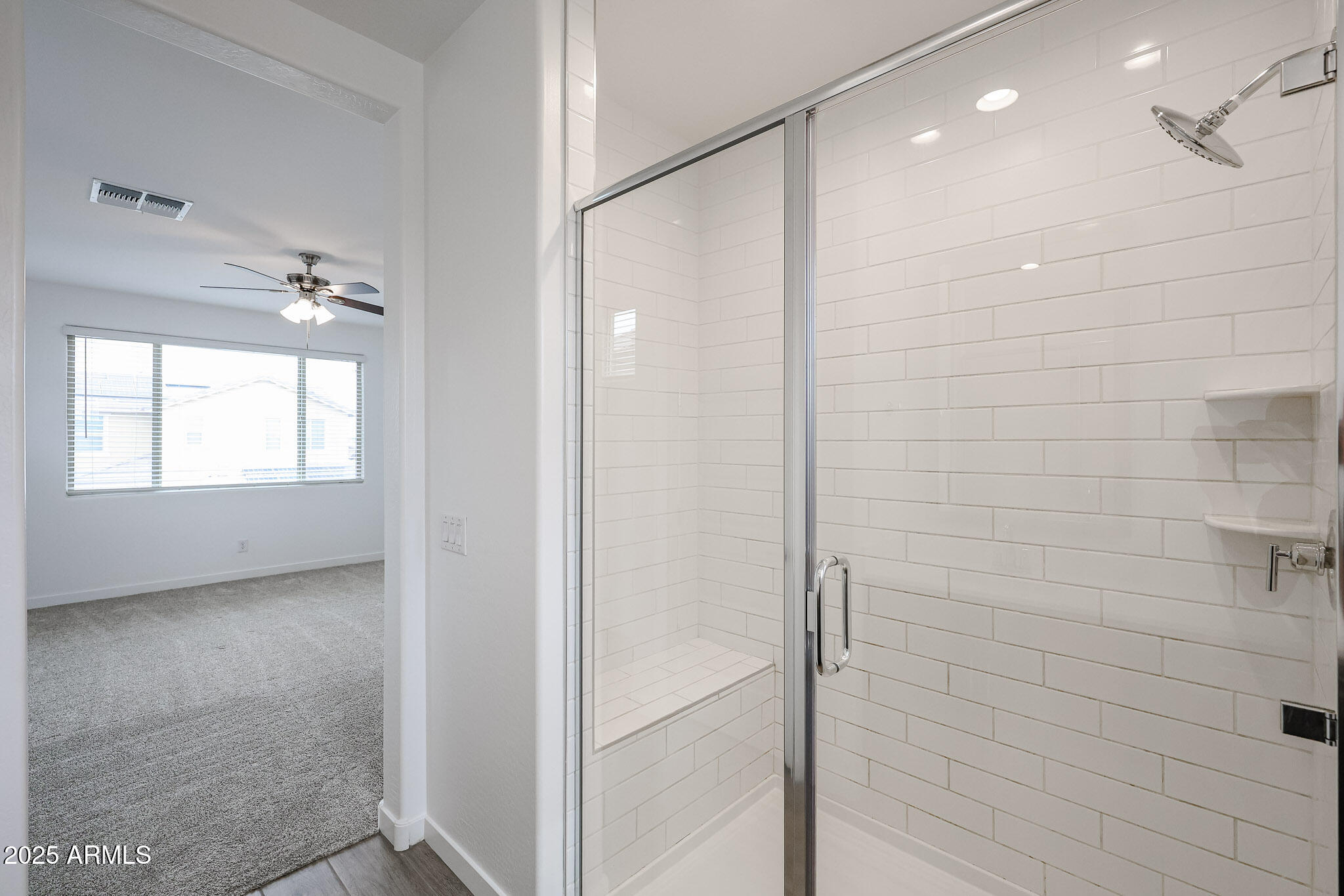 12526 West Morten Avenue Glendale, AZ 85307 - Photo 17 of 27 a bathroom with a shower and a glass door