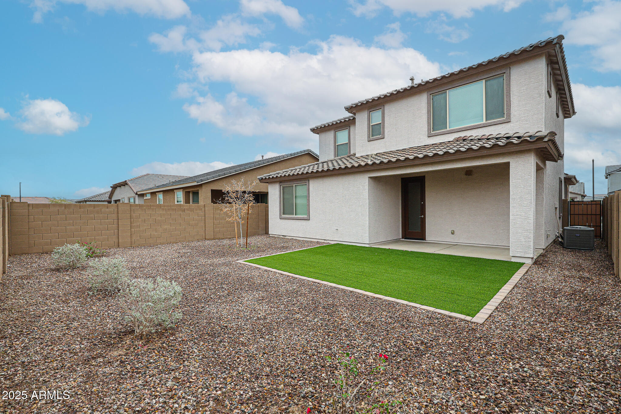 12526 West Morten Avenue Glendale, AZ 85307 - Photo 25 of 27 a view of a house with a yard plants and large tree