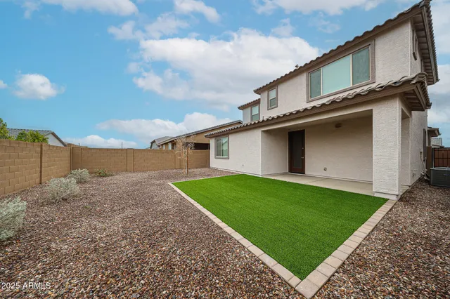 a view of a backyard of the house