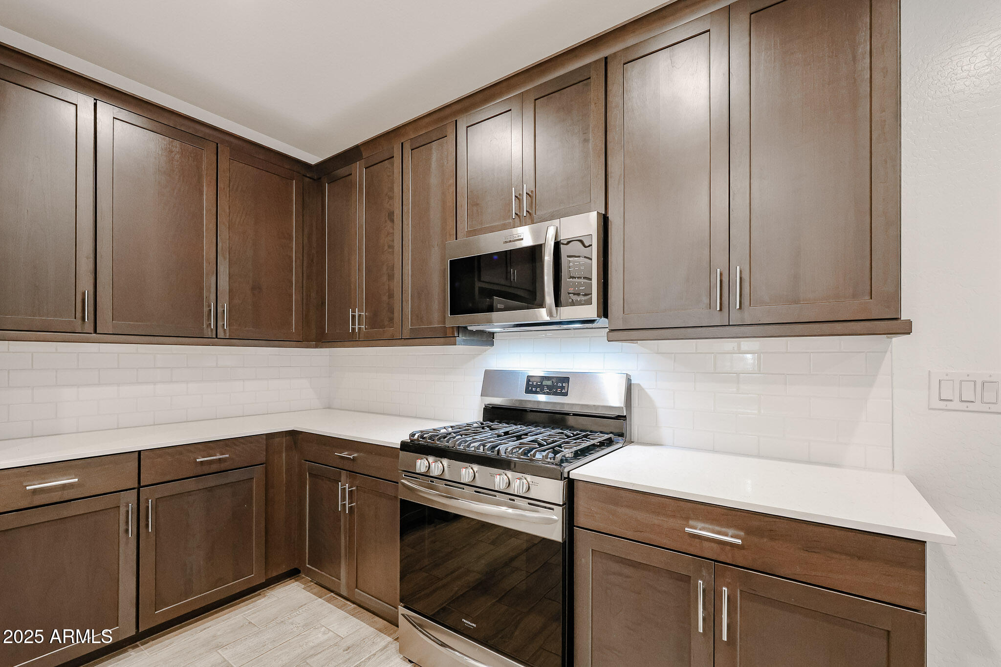 12526 West Morten Avenue Glendale, AZ 85307 - Photo 3 of 27 a kitchen with granite countertop wooden cabinets and stainless steel appliances