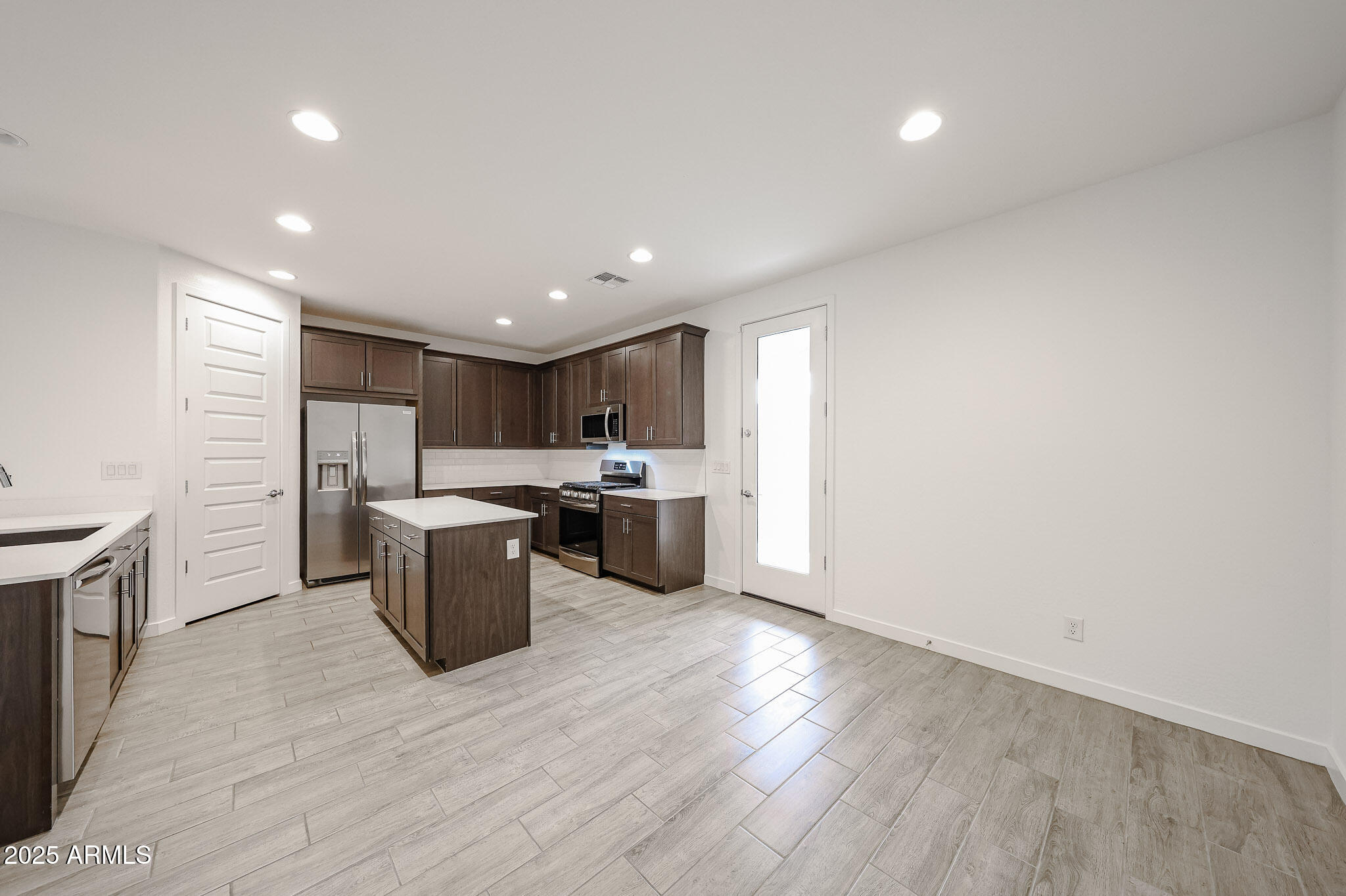 12526 West Morten Avenue Glendale, AZ 85307 - Photo 6 of 27 a kitchen with a sink wooden floor and stainless steel appliances