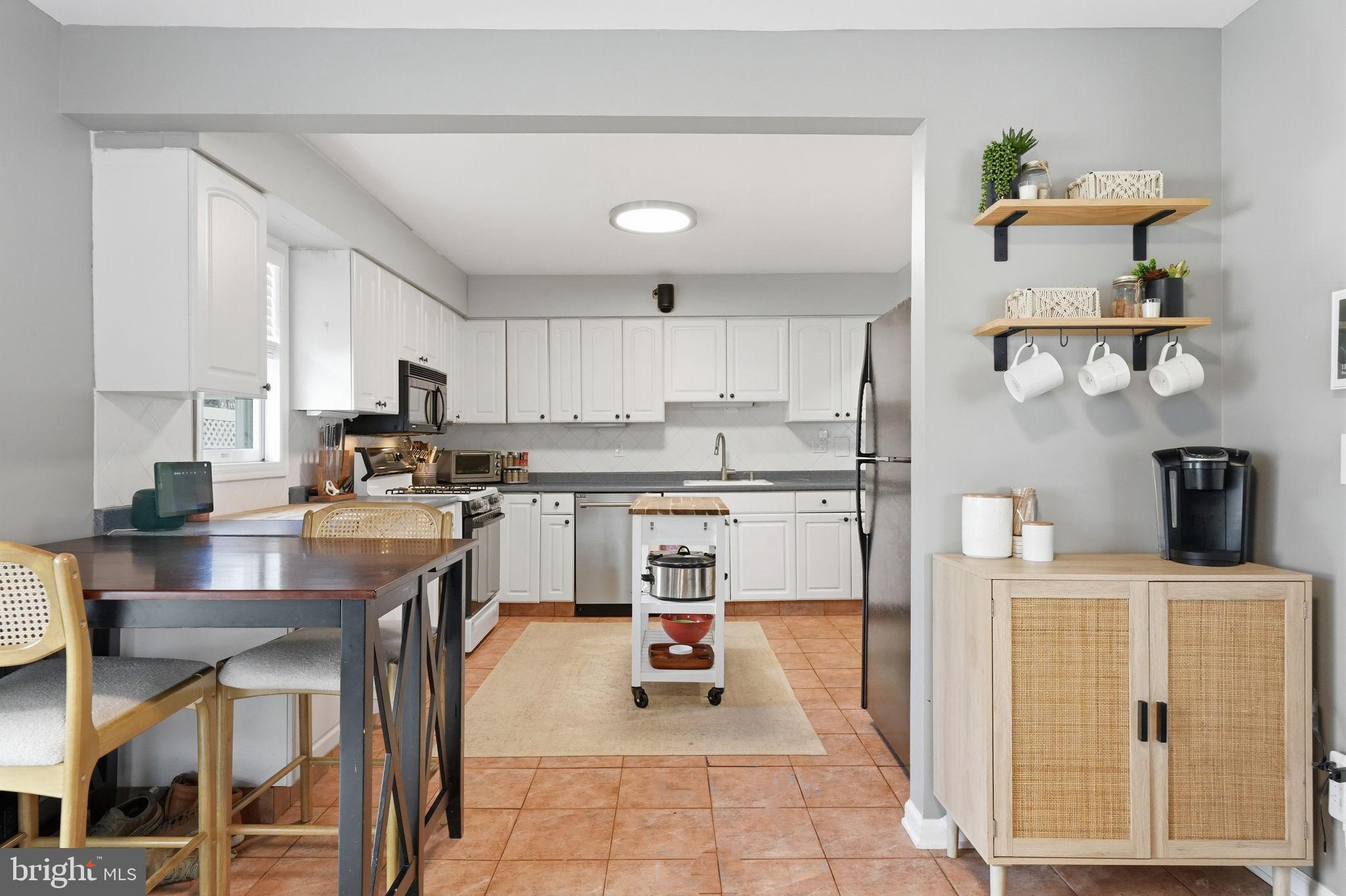 15 Deans Rhode Hall Road Monmouth Junction, NJ 08852 - Photo 13 of 24 a kitchen with stainless steel appliances granite countertop a refrigerator sink and cabinets