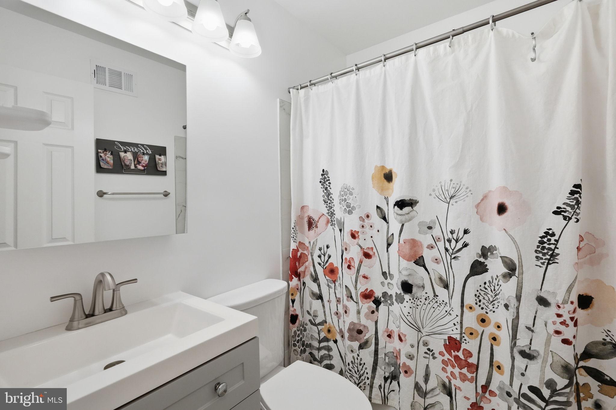 15 Deans Rhode Hall Road Monmouth Junction, NJ 08852 - Photo 19 of 24 a bathroom with a sink and mirror with toilet