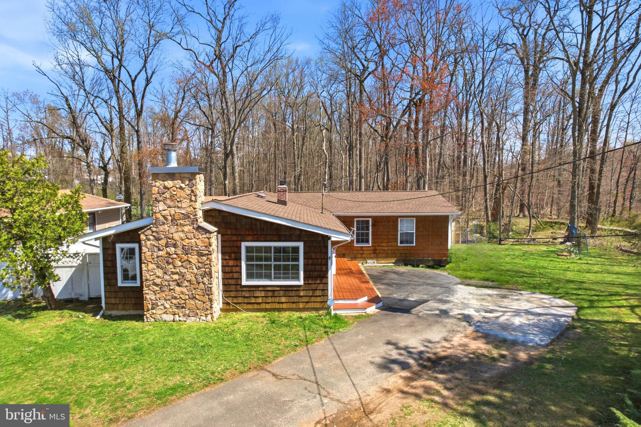 15 Deans Rhode Hall Road Monmouth Junction, NJ 08852 - Photo 2 of 24 a front view of a house with a yard table and chairs