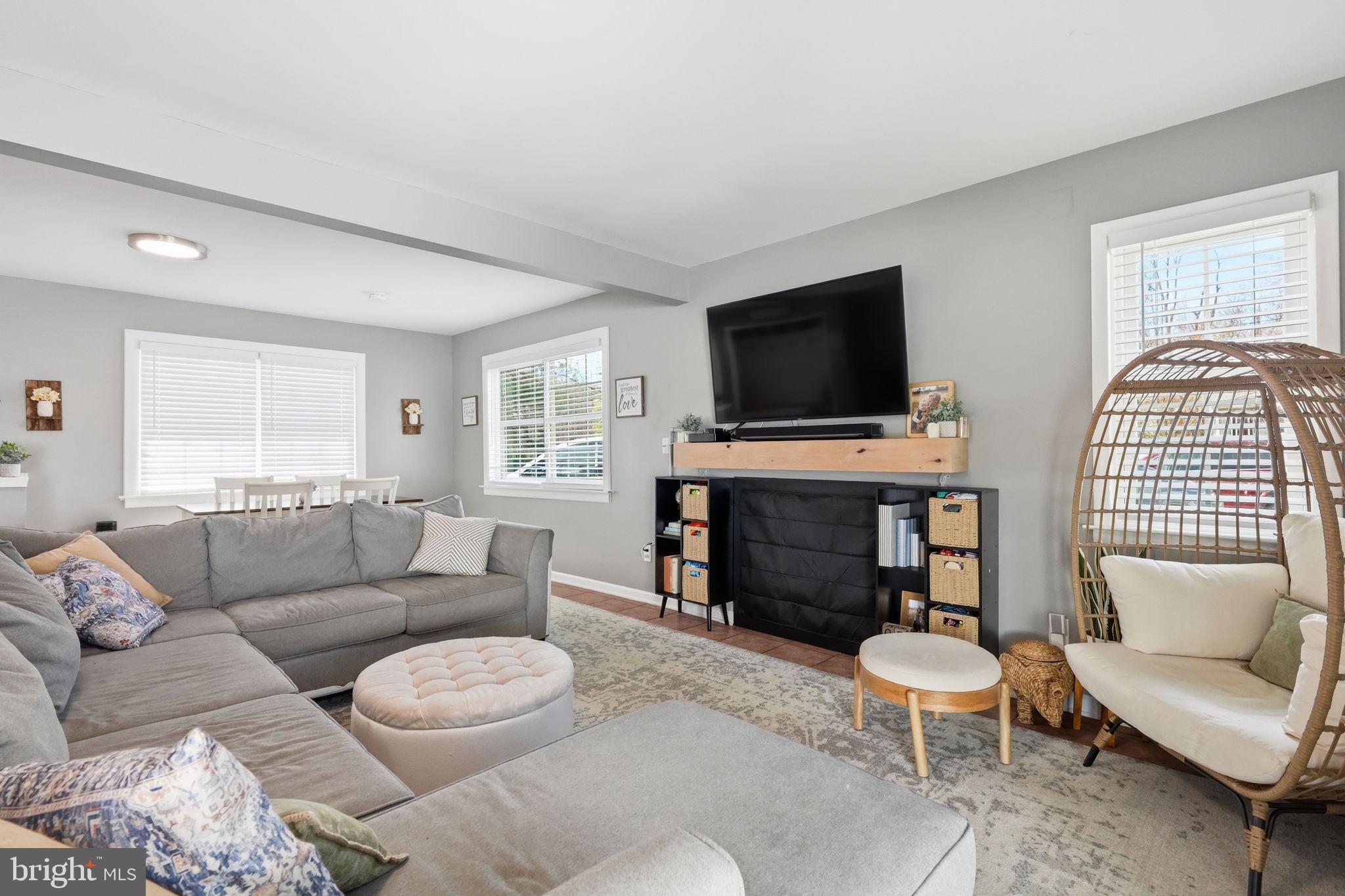 15 Deans Rhode Hall Road Monmouth Junction, NJ 08852 - Photo 7 of 24 a living room with furniture a fireplace and a flat screen tv