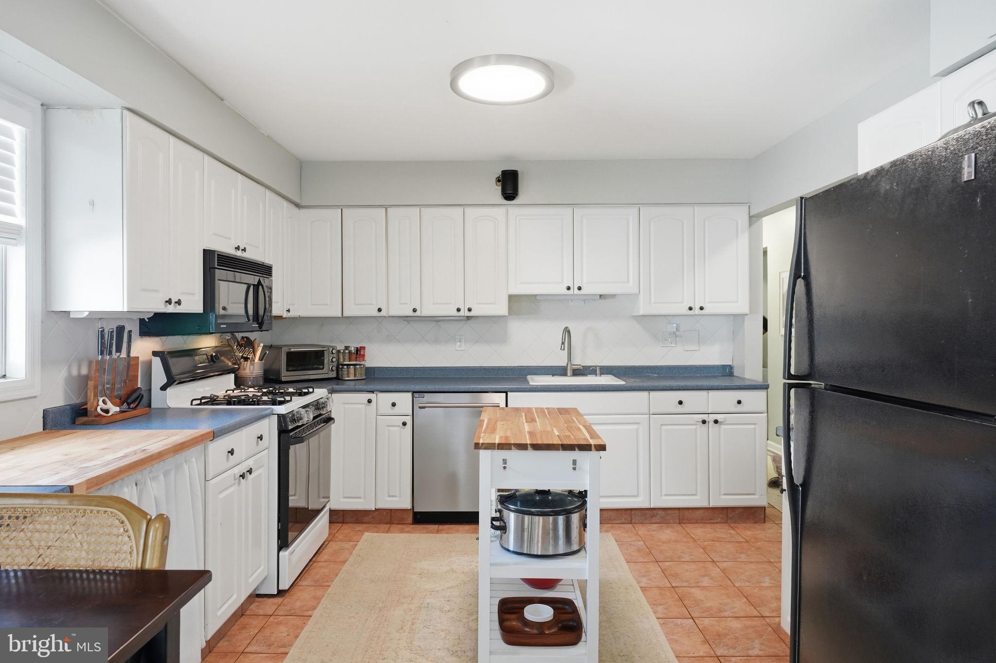 15 Deans Rhode Hall Road Monmouth Junction, NJ 08852 - Photo 10 of 24 a kitchen with a refrigerator a stove a sink and cabinets