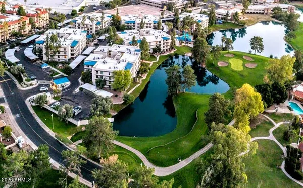 an aerial view of a residential houses with yard