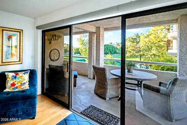 a living room with furniture and large windows