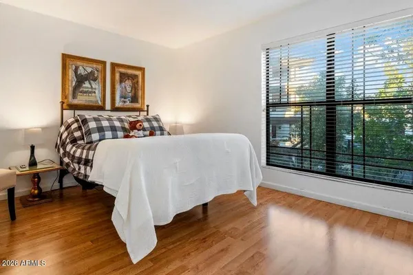 a bed sitting in a bedroom next to a window