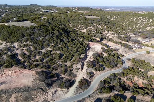 an aerial view of house with yard and mountain view in back