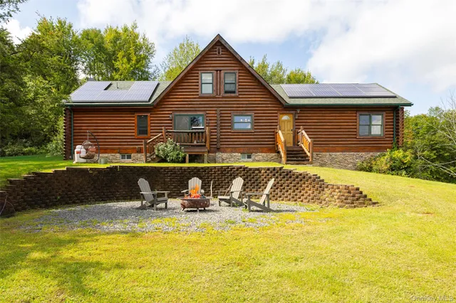 a view of a house with swimming pool and sitting area
