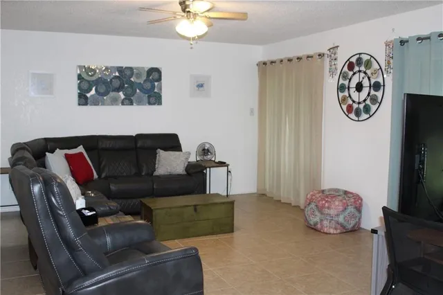 a living room with furniture and a wall painting