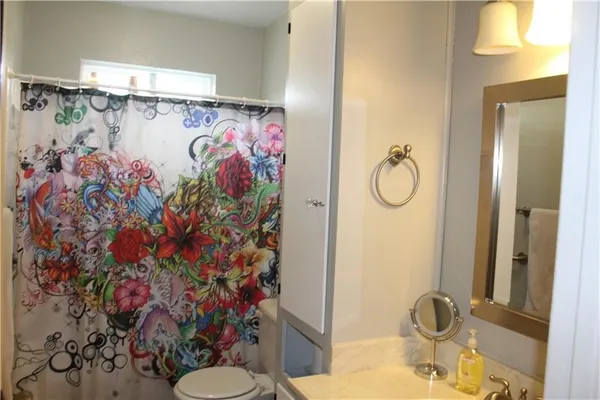 a bathroom with a sink mirror vanity and toilet