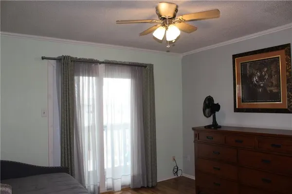 a view of a workspace with a window and a chandelier fan