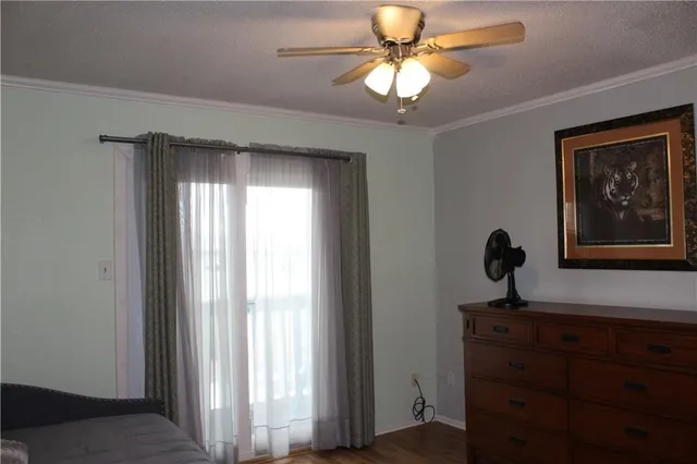 a view of a workspace with a window and a chandelier fan
