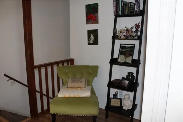 a view of a hallway with wooden floor and a workspace