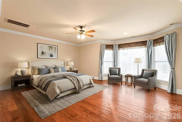 a spacious bedroom with a balcony a bed and a couch