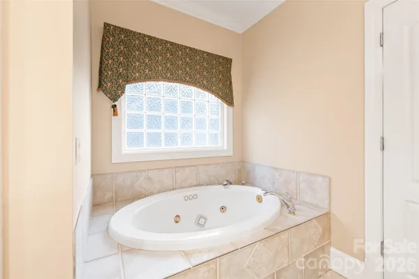 a view of bathroom with bathtub and window