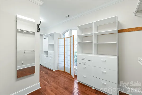 a view of walk in closet with empty racks