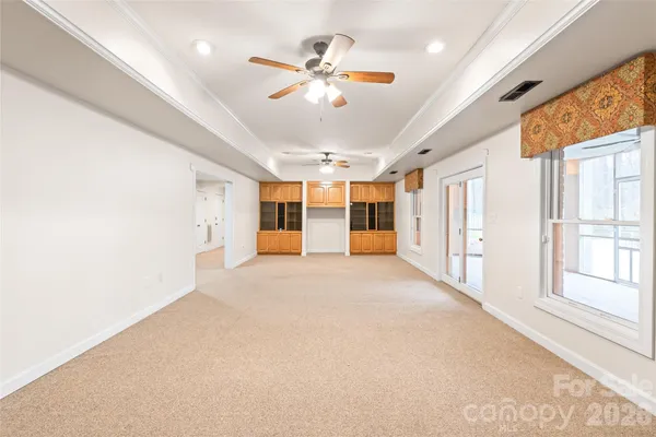 a view of a livingroom with a ceiling fan and window