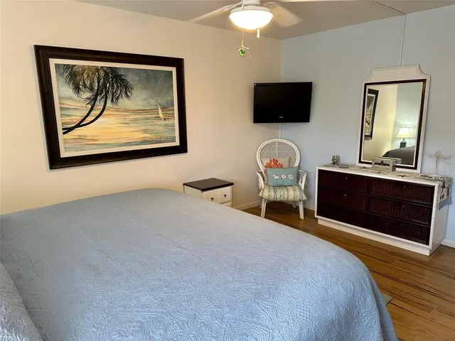 a bedroom with furniture and a flat screen tv